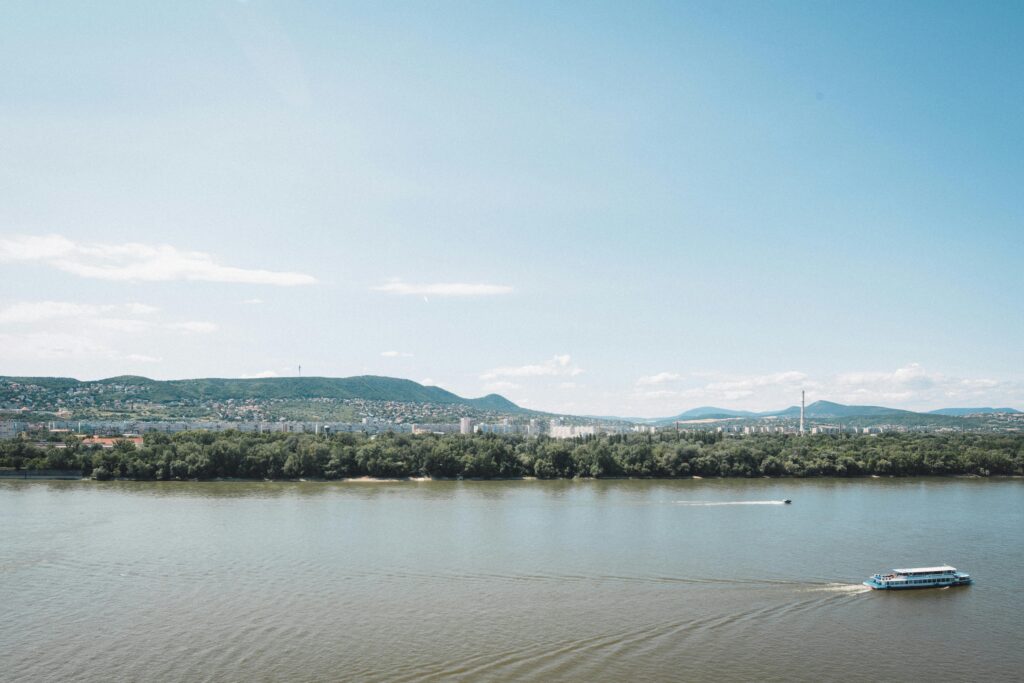 A serene view of the Danube River with a distant panorama of Budapest, Hungary.